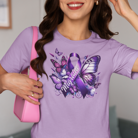 Woman with dark hair and red lipstick carrying a pink purse is wearing a lavender Migraine Awareness t-shirt with a purple Migraine ribbon and butterflies and flowers