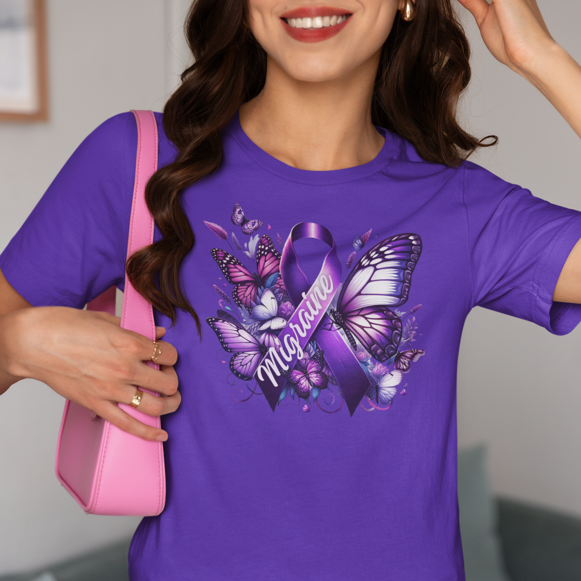Woman with dark hair and red lipstick carrying a pink purse is wearing a purple Migraine Awareness t-shirt with a purple Migraine ribbon and butterflies and flowers