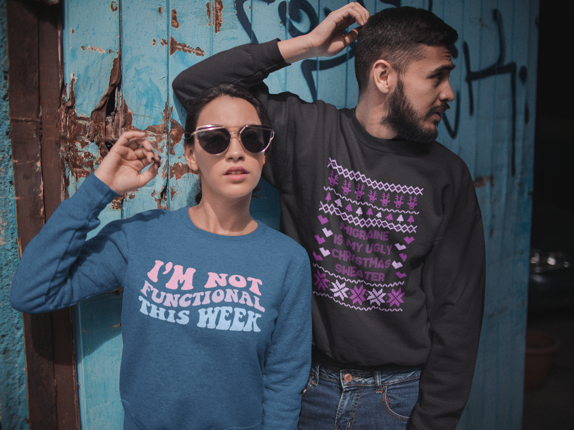 Woman wearing a blue green sweatshirt saying "I'm not functional this week" in a wavy pattern and a man wearing a black sweatshirt saying "Migraine is my ugly Christmas Sweater"